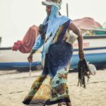 A vibrant scene of a female vendor with ornaments on a Goa beach, embodying coastal culture.